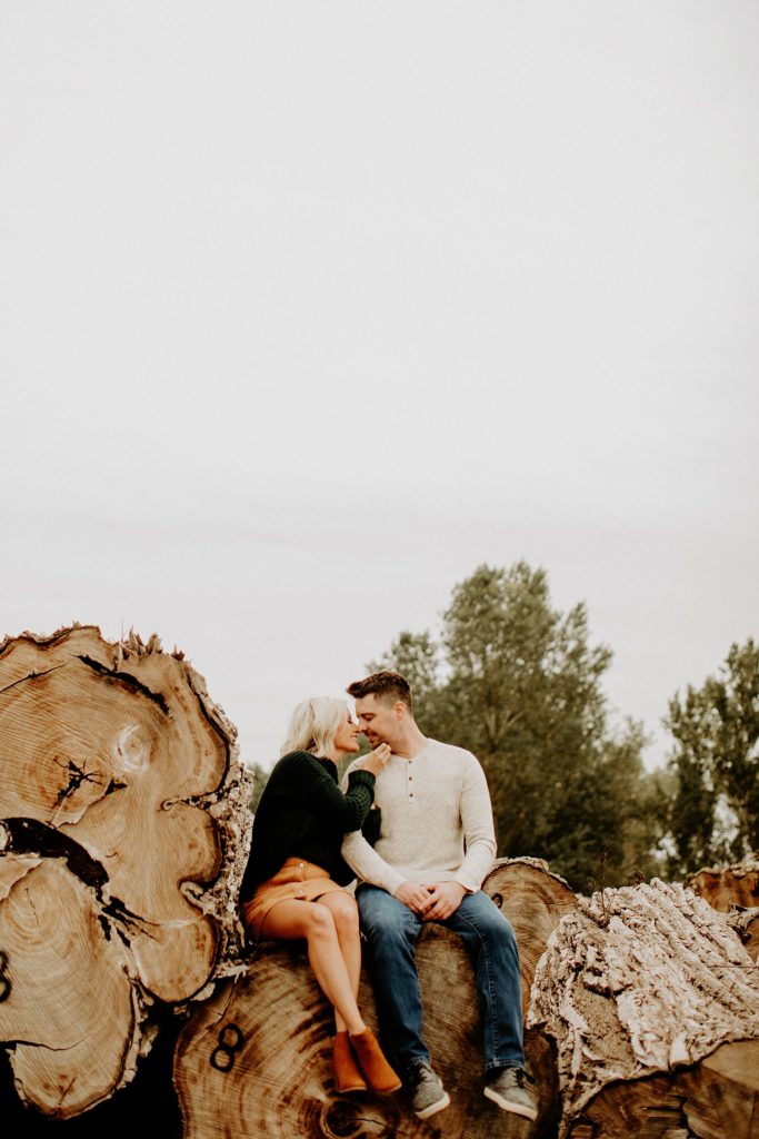 couple sitting on logs