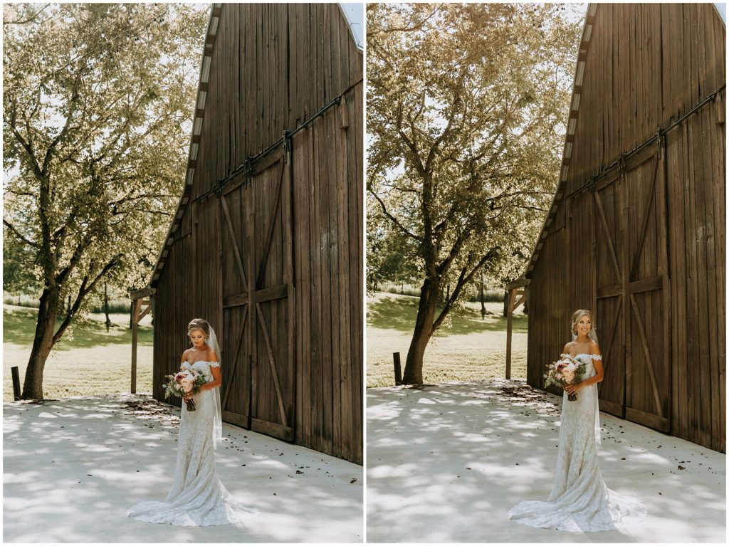 bride posing in front of barn